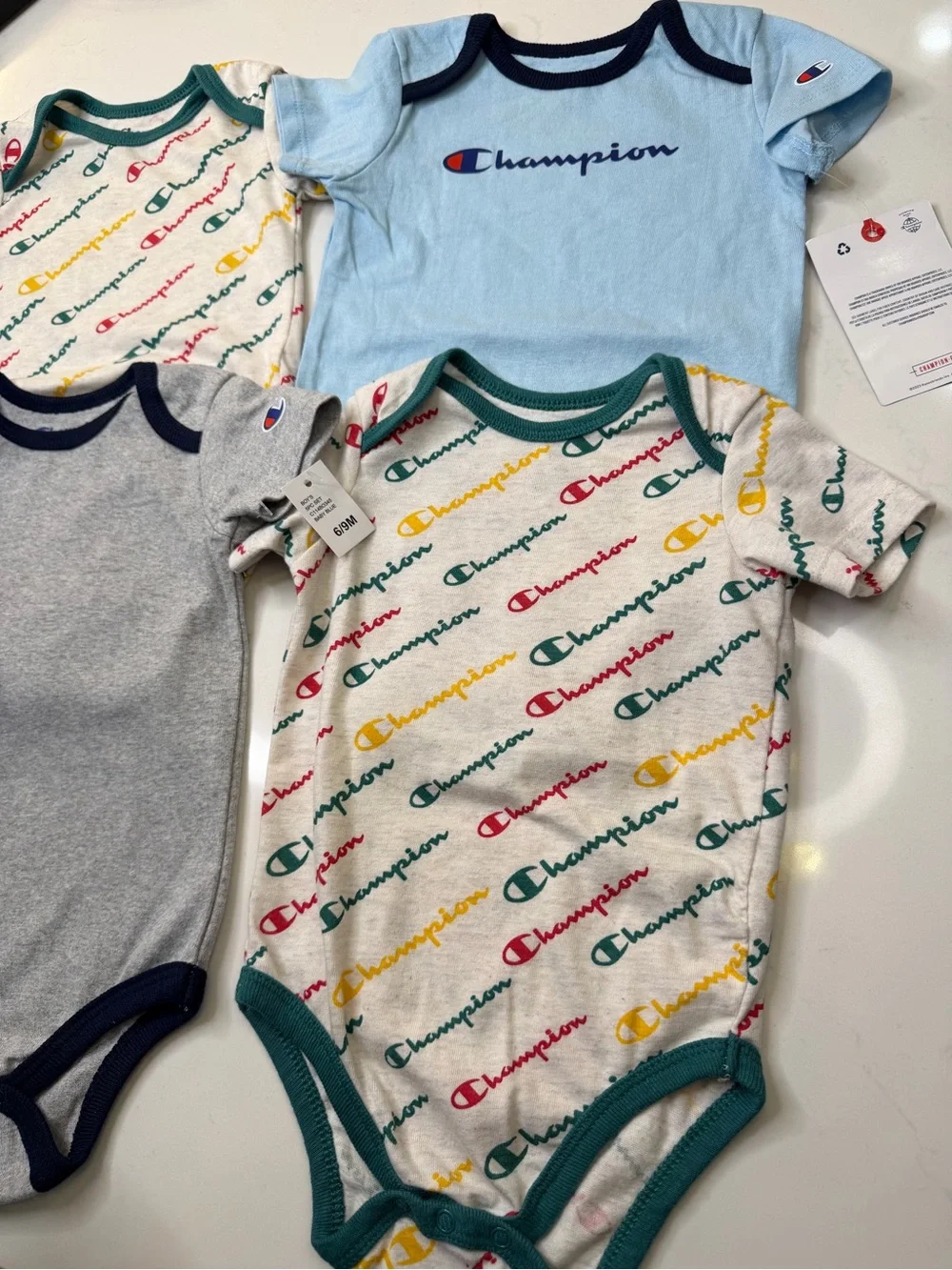 Champion 4-piece baby bodysuit bundle in size 6-9 months/9 months